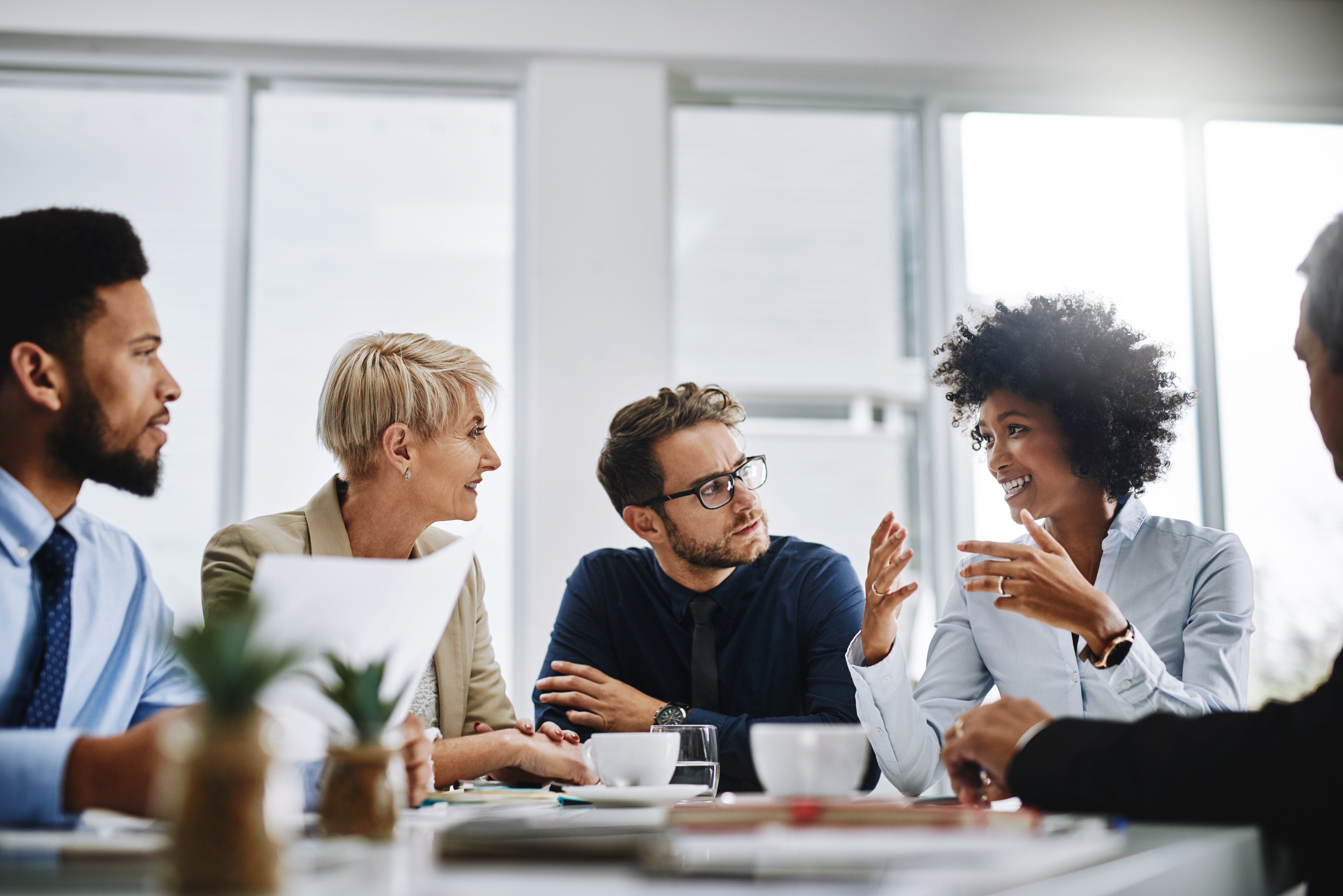 Group of male and female corporate professionals having a discussion